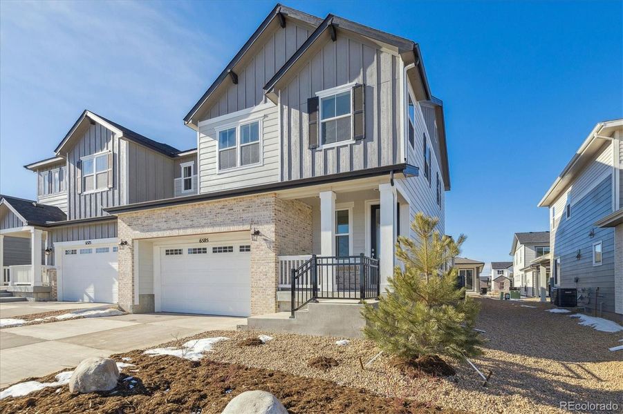 Front exterior of a new home in Skyview at High Point, Aurora, CO, highlighting curb appeal (Image 4).