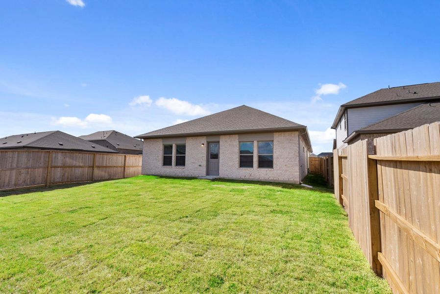 Exterior details and patio area of a home in Windrose Green, Angleton (Image 22).
