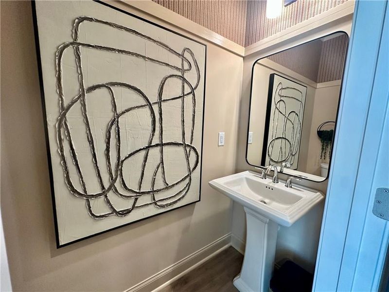 Powder Room located on Main Level for guest access *Images shown are from a decorated model of the same floor plan. Design selections and color packages will vary by home.* Powder Room located on Main Level for guest access *Images shown are from a decorated model of the same floor plan. Design selections and color packages will vary by home.*