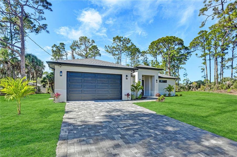 Front exterior of a new home in , North Port, FL, highlighting curb appeal (Image 26). Front exterior of a new home in , North Port, FL, highlighting curb appeal (Image 26).