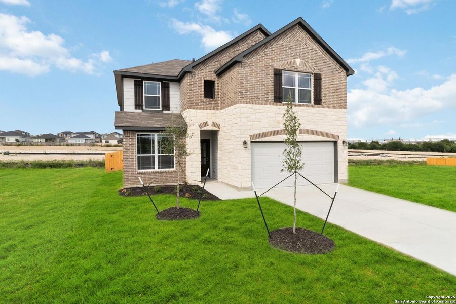 Front exterior of a new home in Hunters Ranch, San Antonio, TX, highlighting curb appeal (Image 13). Front exterior of a new home in Hunters Ranch, San Antonio, TX, highlighting curb appeal (Image 13).