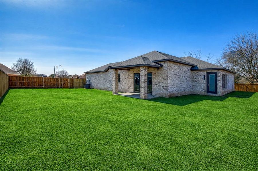 Virtually staged grass in photo until actual grass grows in.