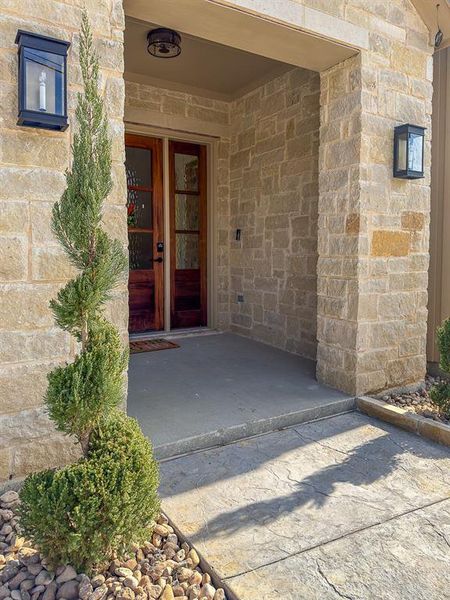 Stone veneer exterior with a covered entry