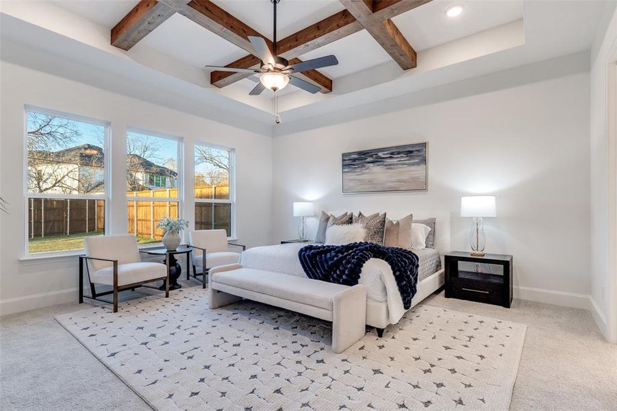 Luxe primary bedroom with coffered ceiling, light carpet, and beamed ceiling. Luxe primary bedroom with coffered ceiling, light carpet, and beamed ceiling.