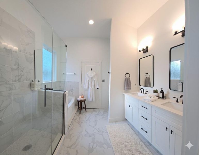 Spa like bath with dual vanity sinks and a glass enclosed shower and separate soaking garden tub.