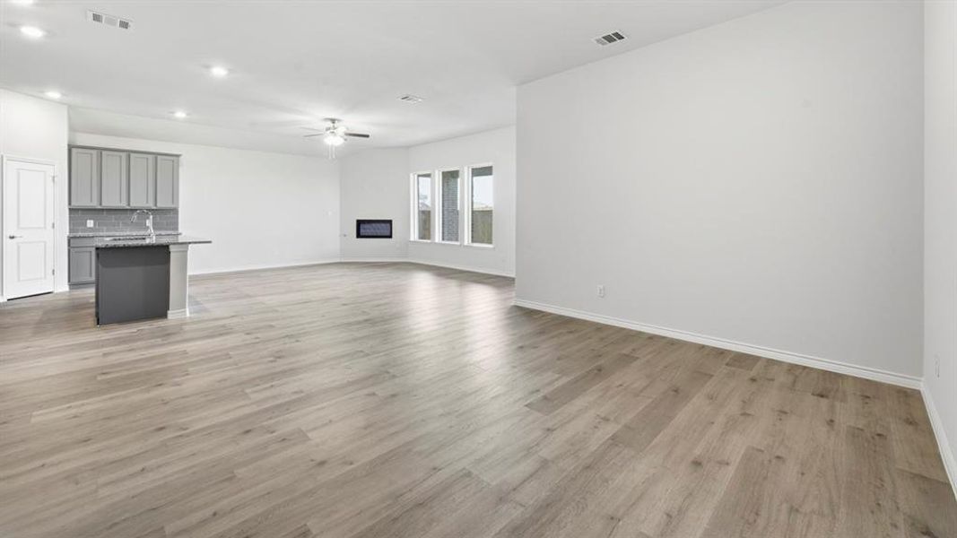 Unfurnished living room with light wood-style floors, recessed lighting, and a ceiling fan Unfurnished living room with light wood-style floors, recessed lighting, and a ceiling fan