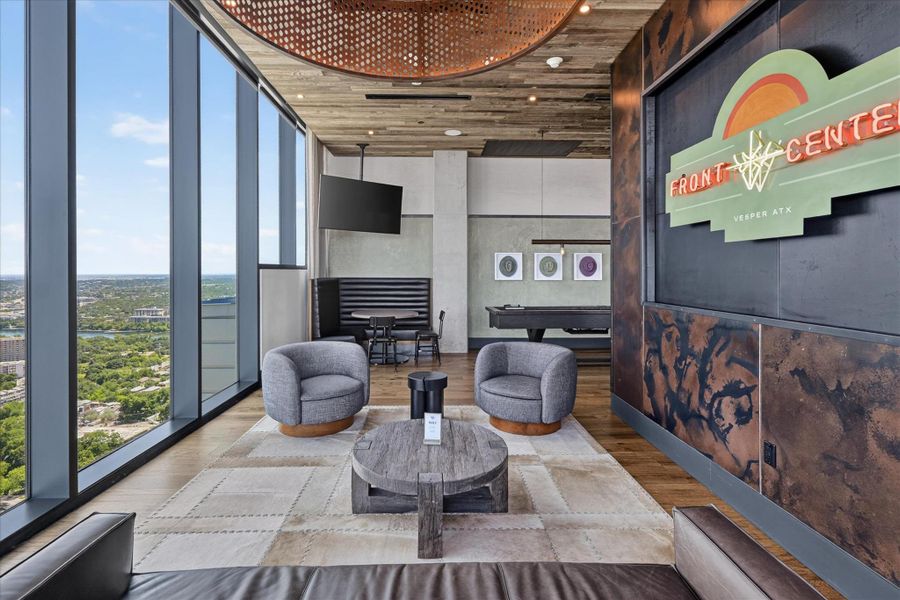 An inviting community space offers spectacular views, a billiards table, and comfortable seating with modern finishes.