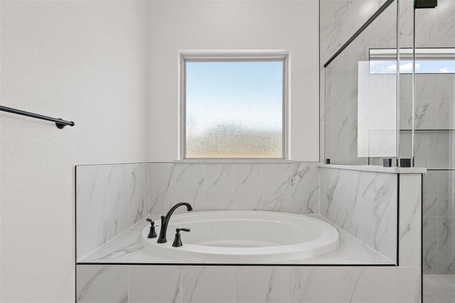 Full bath with a bath and a marble finish shower