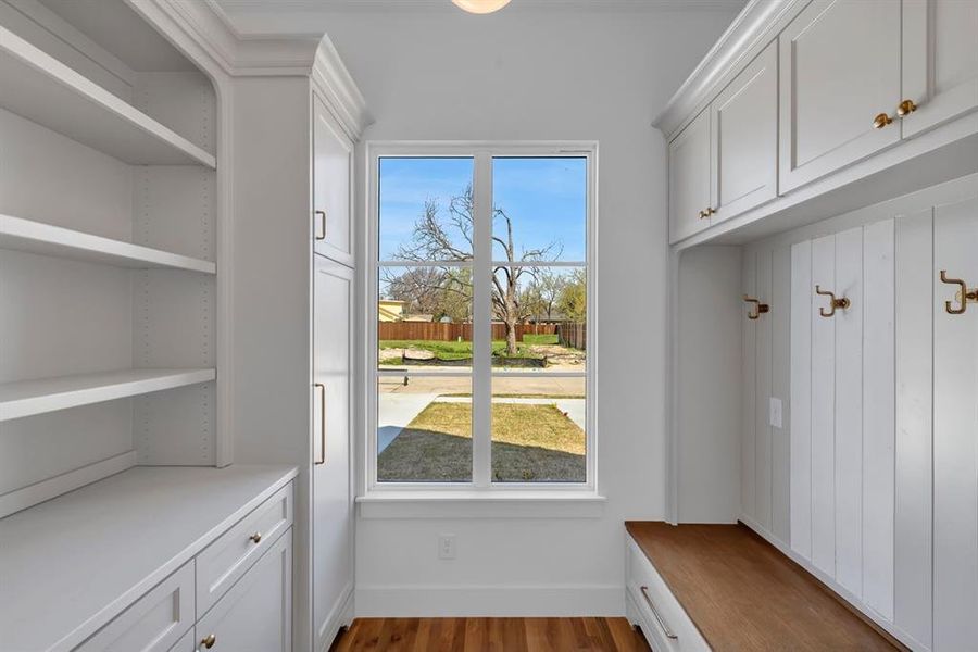 Mudroom with dark wood-type flooring and baseboards