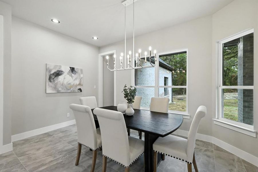 Dining space with recessed lighting and a chandelier