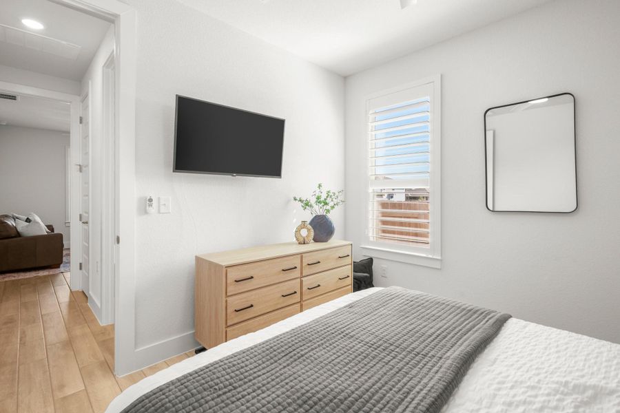 Bedroom featuring light wood-style floors and baseboards