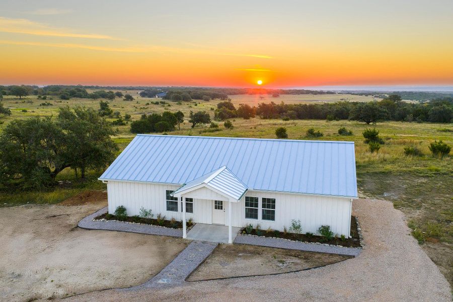 Property at dusk featuring a water view and a view of countryside Property at dusk featuring a water view and a view of countryside