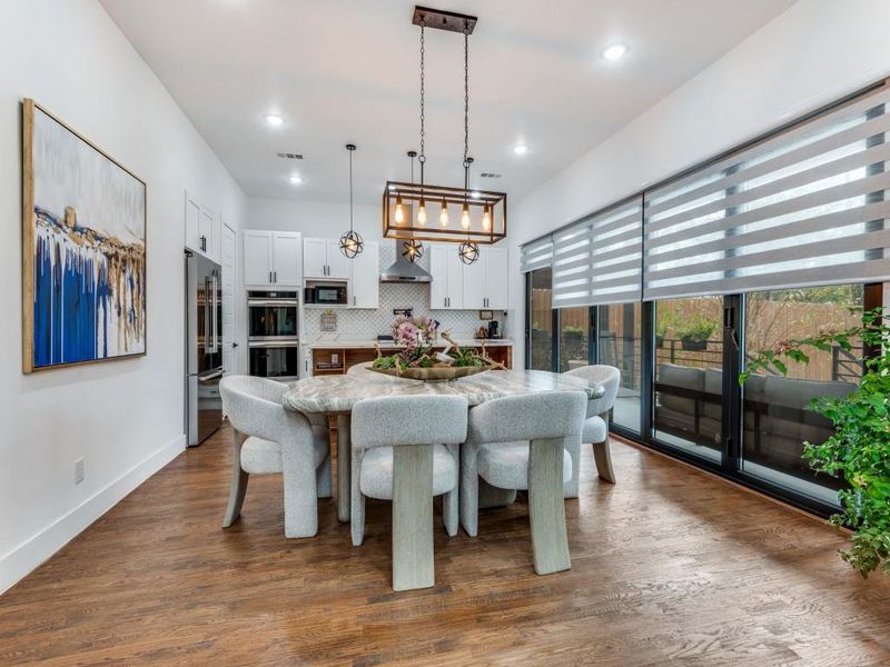 Dining space with dark wood-style flooring and recessed lighting