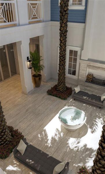 The courtyard features seating areas and a fireplace, perfect for entertaining.