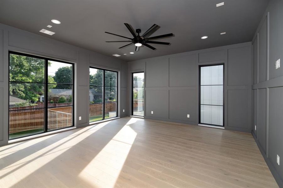 Unfurnished room with ceiling fan and light hardwood / wood-style flooring