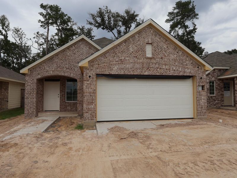 Front exterior of a new home in Pinewood at Grand Texas, New Caney, TX, highlighting curb appeal (Image 2).