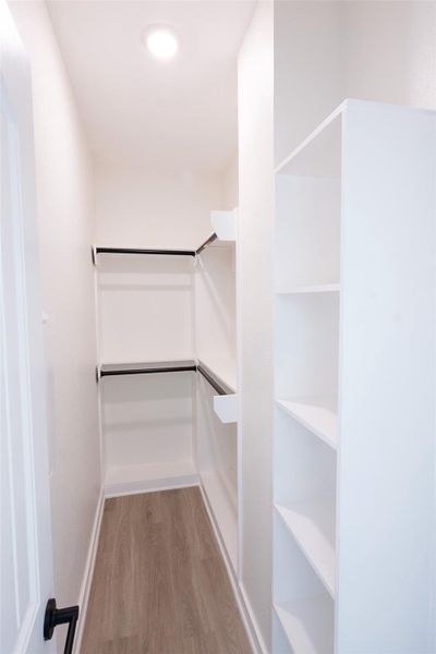 Primary bedroom walk in closet