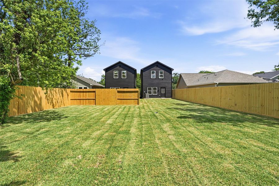 This large backyard is completely fenced in. There’s room for the dog to run around, with plenty of space to lounge, host BBQ, and entertain.