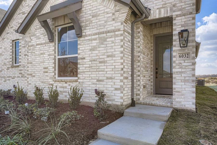 Doorway to property featuring brick siding Doorway to property featuring brick siding