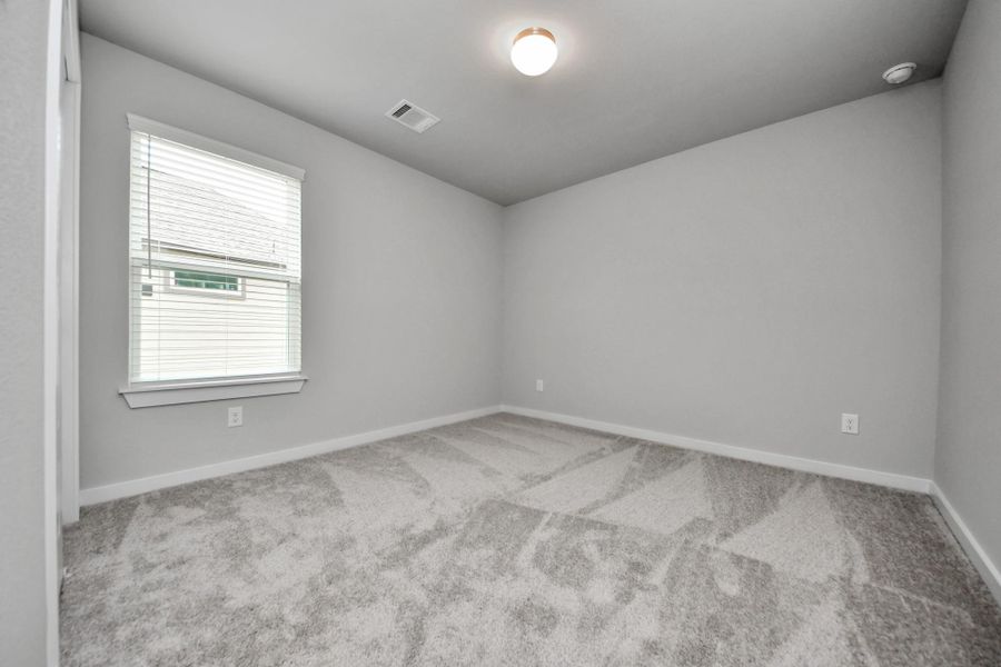 Experience outdoor living at its finest on this expansive covered patio, thoughtfully designed for BBQs and delightful outdoor dining. Sample photo of completed home with similar floor plan. Actual colors and selections may vary.
