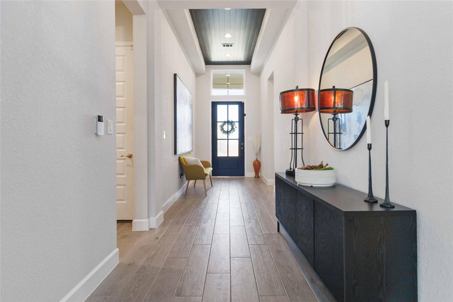 Entrance foyer with light wood-type flooring and baseboards Entrance foyer with light wood-type flooring and baseboards