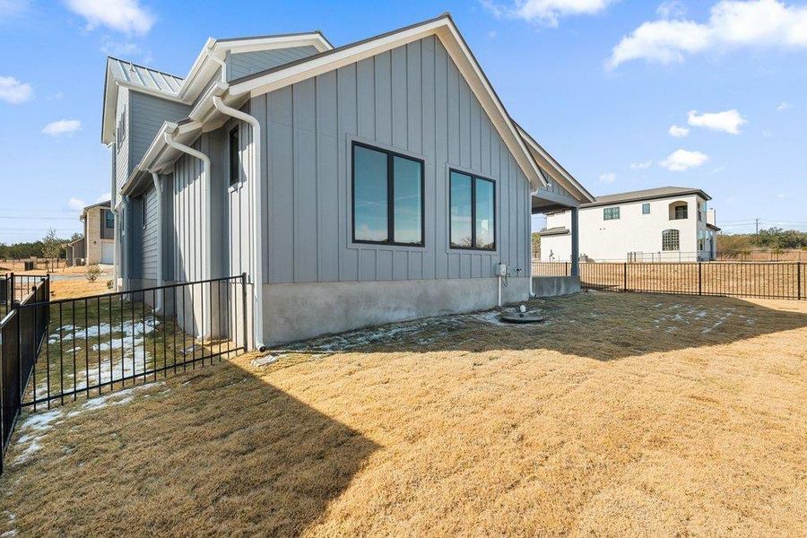 View of side of home featuring board and batten siding and a garage