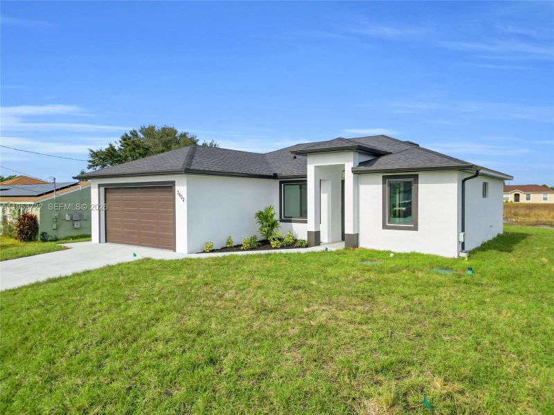 Front exterior of a new home in , Lehigh Acres, FL, highlighting curb appeal (Image 28). Front exterior of a new home in , Lehigh Acres, FL, highlighting curb appeal (Image 28).