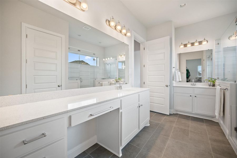 Bathroom with two vanities, a stall shower, tile patterned floors, and recessed lighting