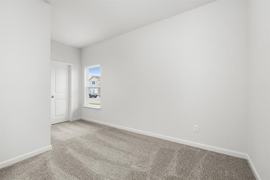 Carpeted empty room with baseboards