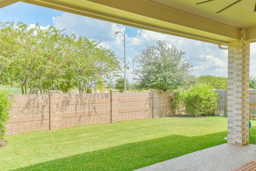 One of the many subdivision lakes is visible from the extended covered back porch. One of the many subdivision lakes is visible from the extended covered back porch.
