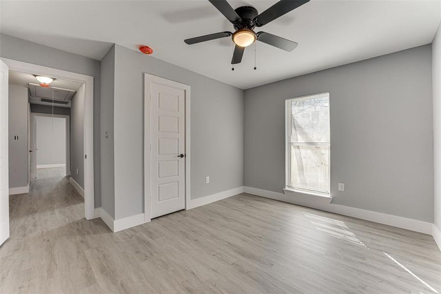 Unfurnished bedroom with ceiling fan and light hardwood / wood-style flooring