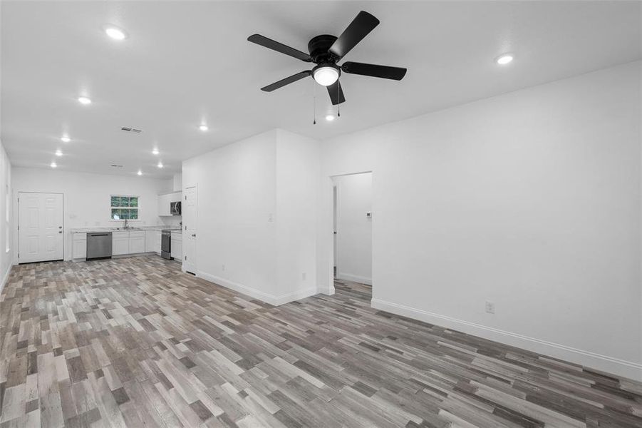 Unfurnished living room featuring recessed lighting, light wood-type flooring, and ceiling fan