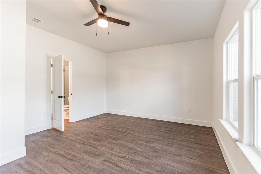 Spare room featuring ceiling fan and dark hardwood / wood-style floors