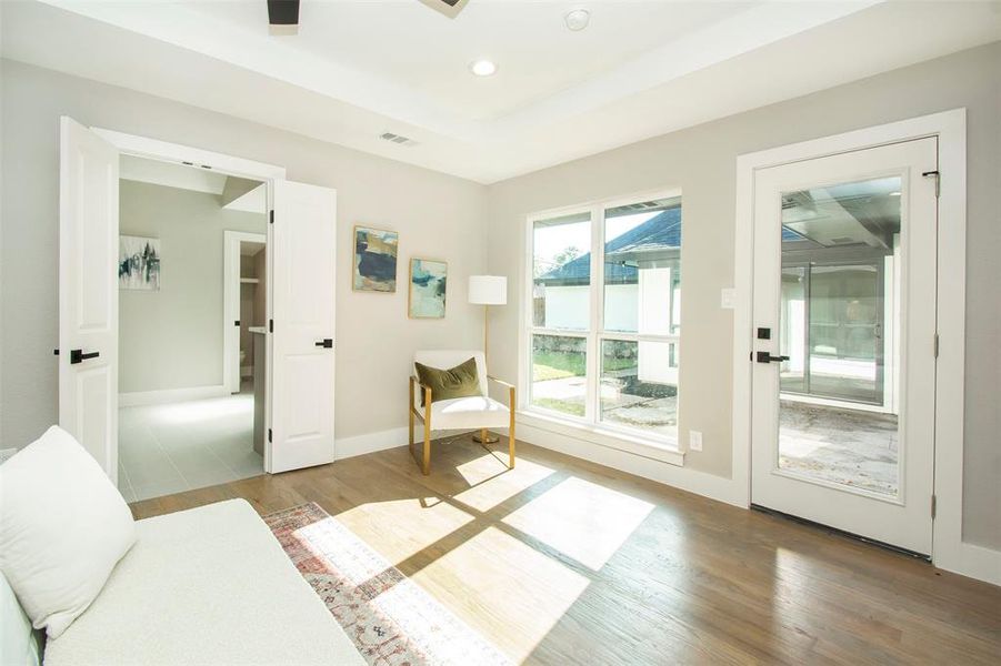 Doorway to outside featuring ceiling fan and light hardwood / wood-style floors