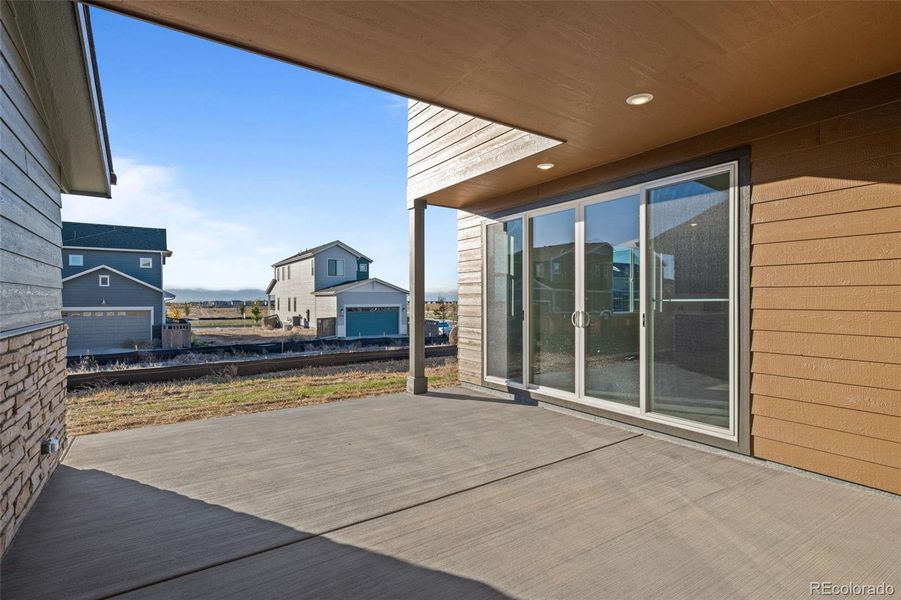 Exterior details and patio area of a home in Painted Prairie, Aurora (Image 24).