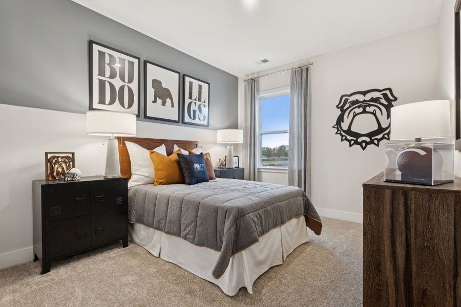 A bedroom with a bed and a desk.