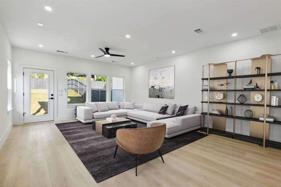 Living room featuring light hardwood / wood-style flooring and ceiling fan