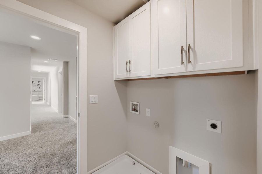 Ample overhead cabinetry provides smart storage in this functional laundry space. Ample overhead cabinetry provides smart storage in this functional laundry space.