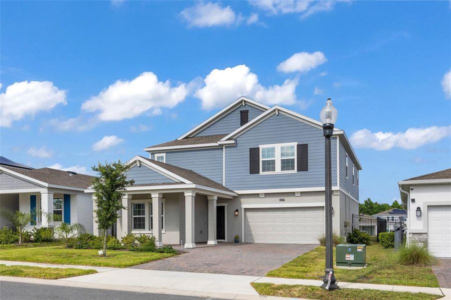 Front exterior of a new home in Providence, Davenport, FL, highlighting curb appeal (Image 22).