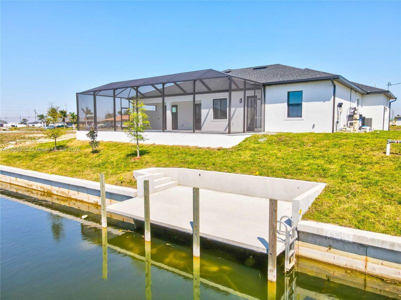 Back of property with a concrete dock