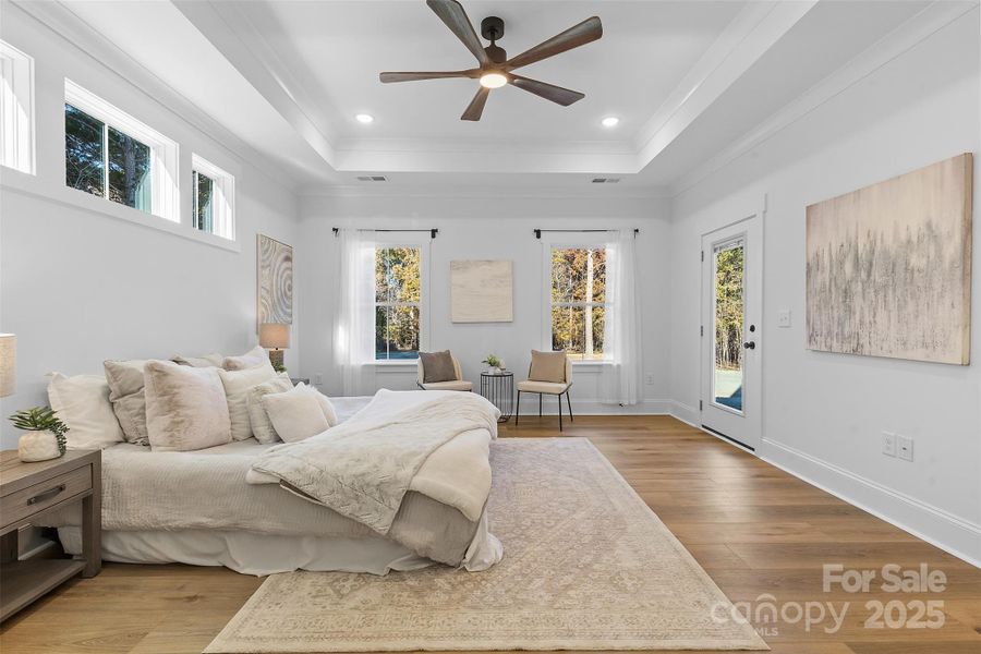 *representative photo- primary bedroom w/ tray ceiling, additional windows for natural light, ensuite bathroom, and a private access to the covered back porch!