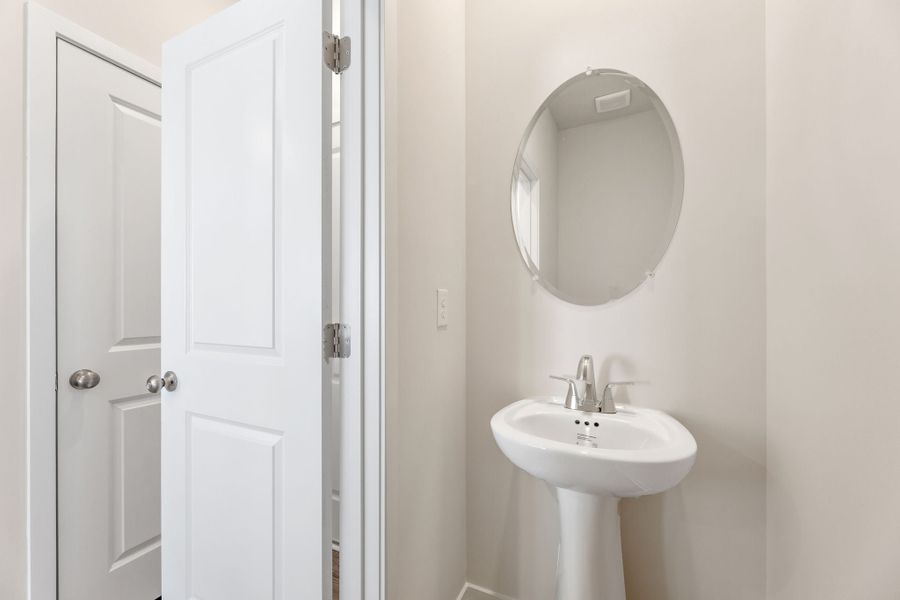 A bathroom with a round mirror. A bathroom with a round mirror.
