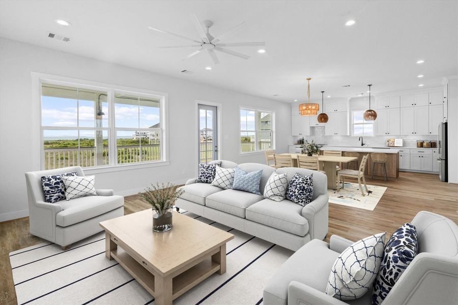 Experience breathtaking views in this stunning open-concept living space, flooded with natural light from expansive windows.