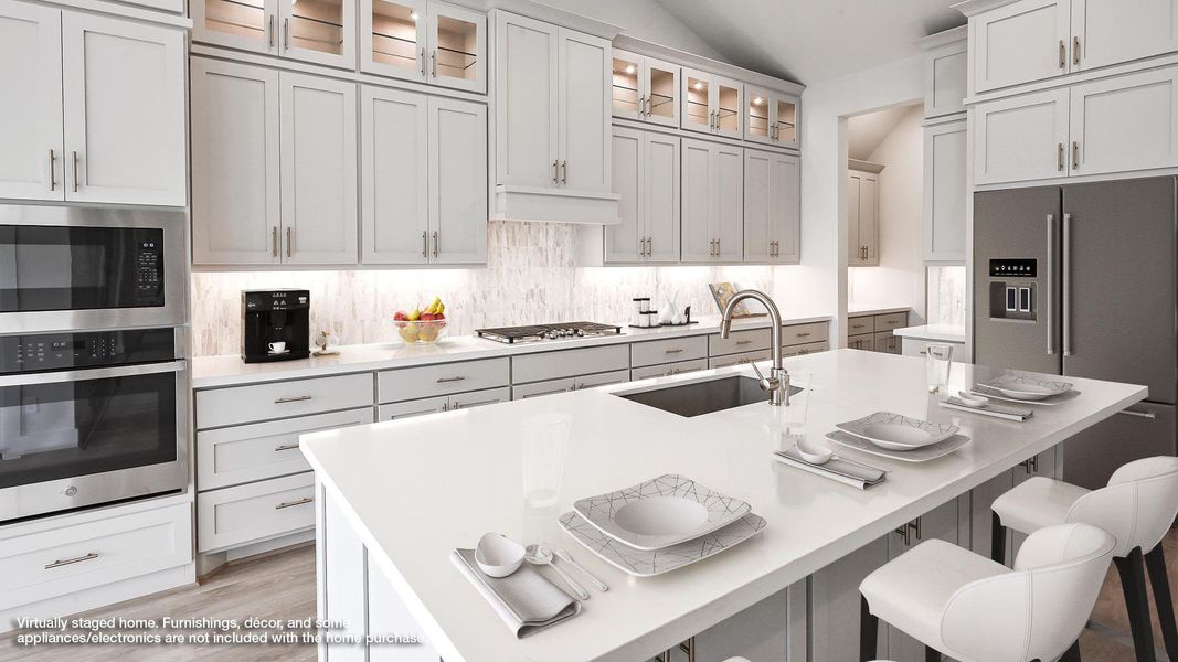 Kitchen featuring stainless steel appliances, a breakfast bar, lofted ceiling, backsplash, and glass insert cabinets
