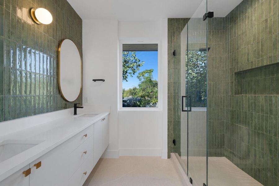 Full bathroom with double vanity, a stall shower, and light tile patterned floors