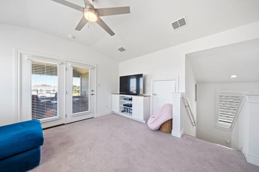 Plush carpeting and vaulted ceilings enhance this upper-level living space complete with outdoor access. Plush carpeting and vaulted ceilings enhance this upper-level living space complete with outdoor access.