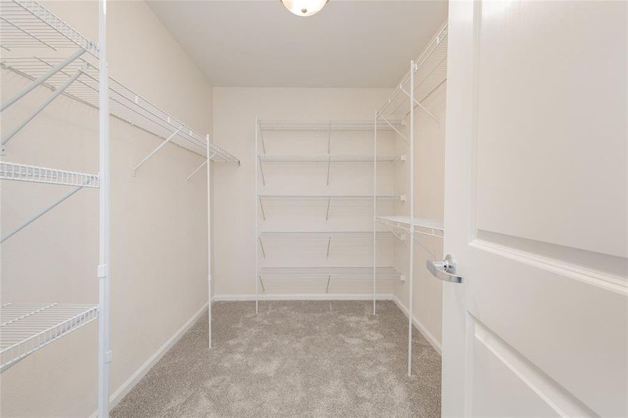 Walk-in 11 x 7 closet in primary bedroom Walk-in 11 x 7 closet in primary bedroom