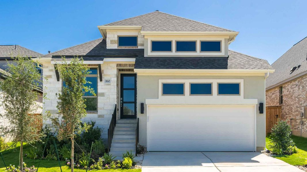 View of front of property with roof with shingles, stone siding, concrete driveway, stucco siding, and an attached garage View of front of property with roof with shingles, stone siding, concrete driveway, stucco siding, and an attached garage