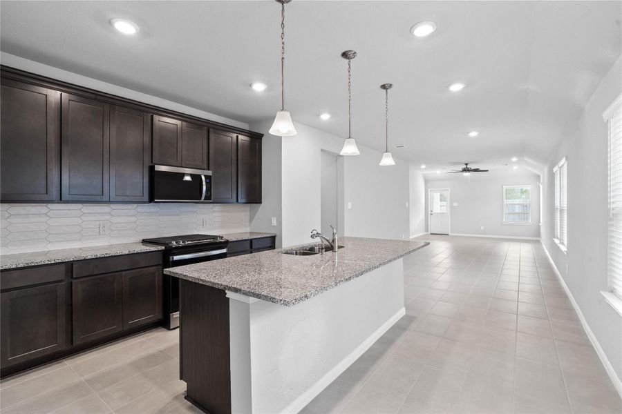 The expansive granite-topped island stands as the home's true heartbeat, offering a natural gathering spot where family and friends naturally gravitate to share meals, conversation, and connection.