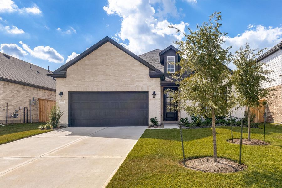 Front exterior of a new home in Mavera, Conroe, TX, highlighting curb appeal (Image 2).